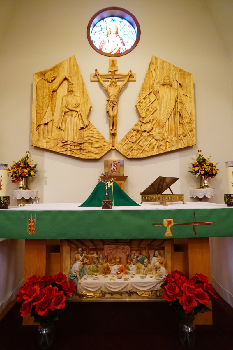 Photo of the main altar with a wooden crucifix above it