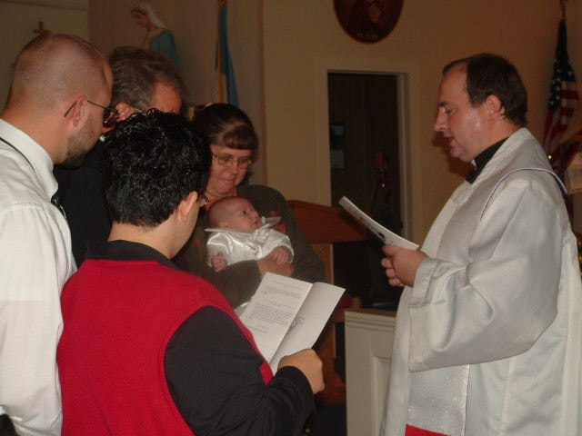 Rev. Boguslaw Janiec leading a baptism